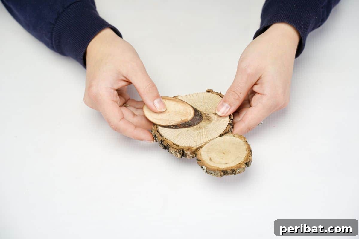 gluing the oval wood slice wing onto the side of the wood slice chick