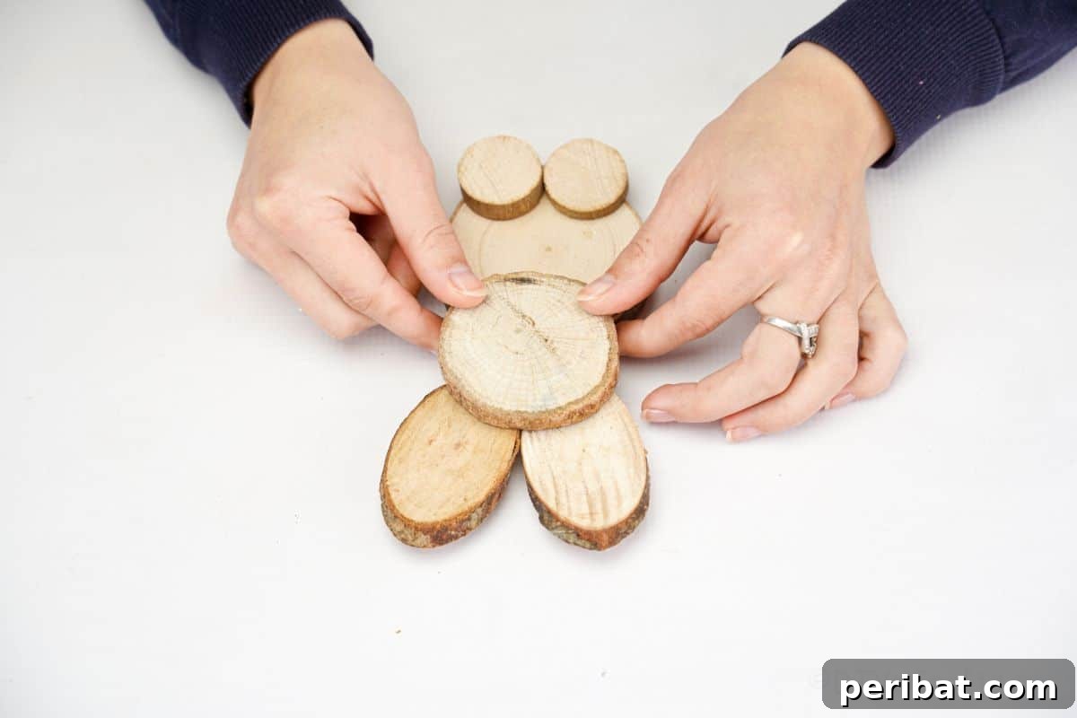 hand holding wood slice on bunny form to seal and glue in place