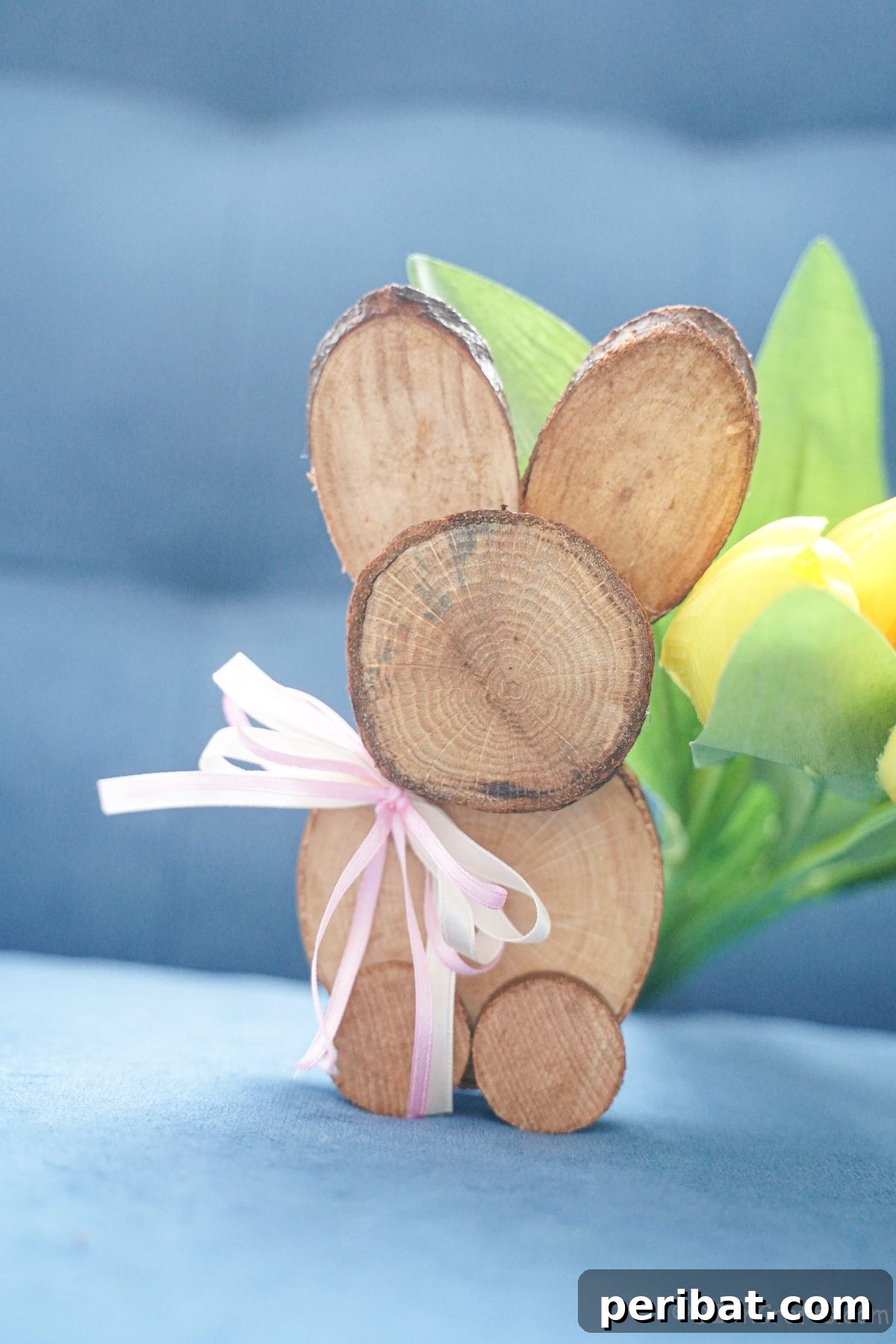 wood slice bunny on blue sofa