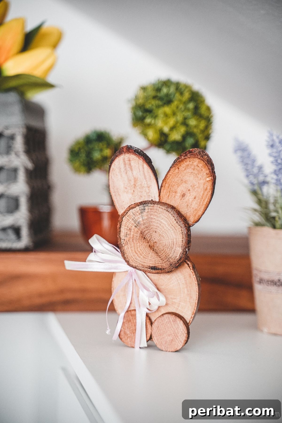 bunny decoration on white table with flowers in background