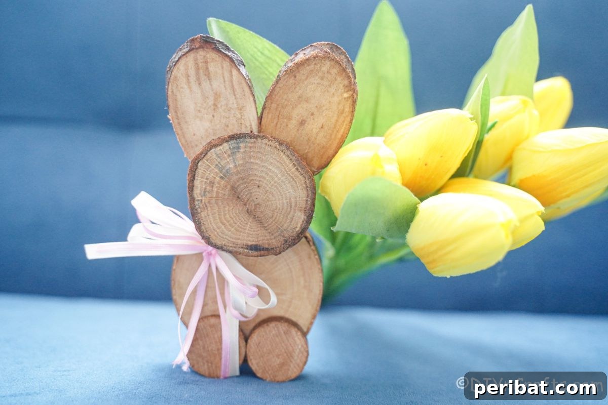 yellow flowers behind wood slice bunny on couch
