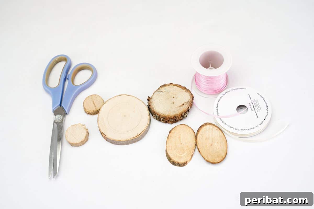 wood slices pink ribbon and scissors on white table