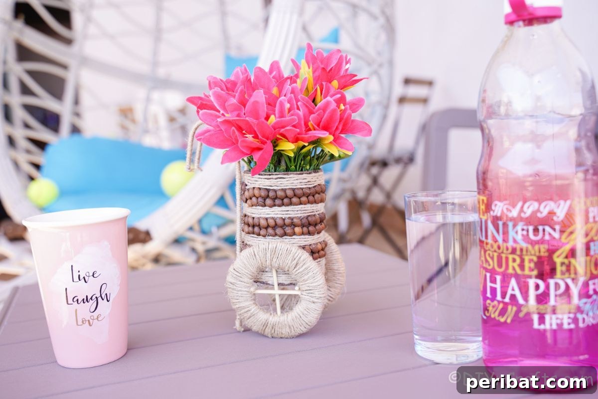 Beautiful rustic tin can vase adorned with coffee beans and twine, holding vibrant pink flowers on a table.