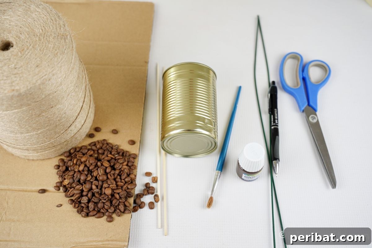 Crafting supplies including a tin can, cardboard, coffee beans, twine, and scissors laid out on a white table.
