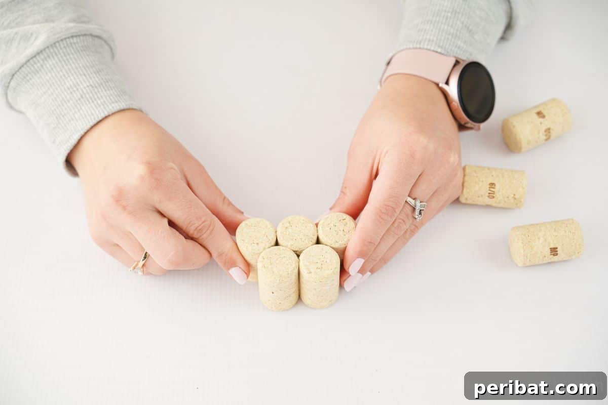 Hand holding corks together to form a grape cluster.