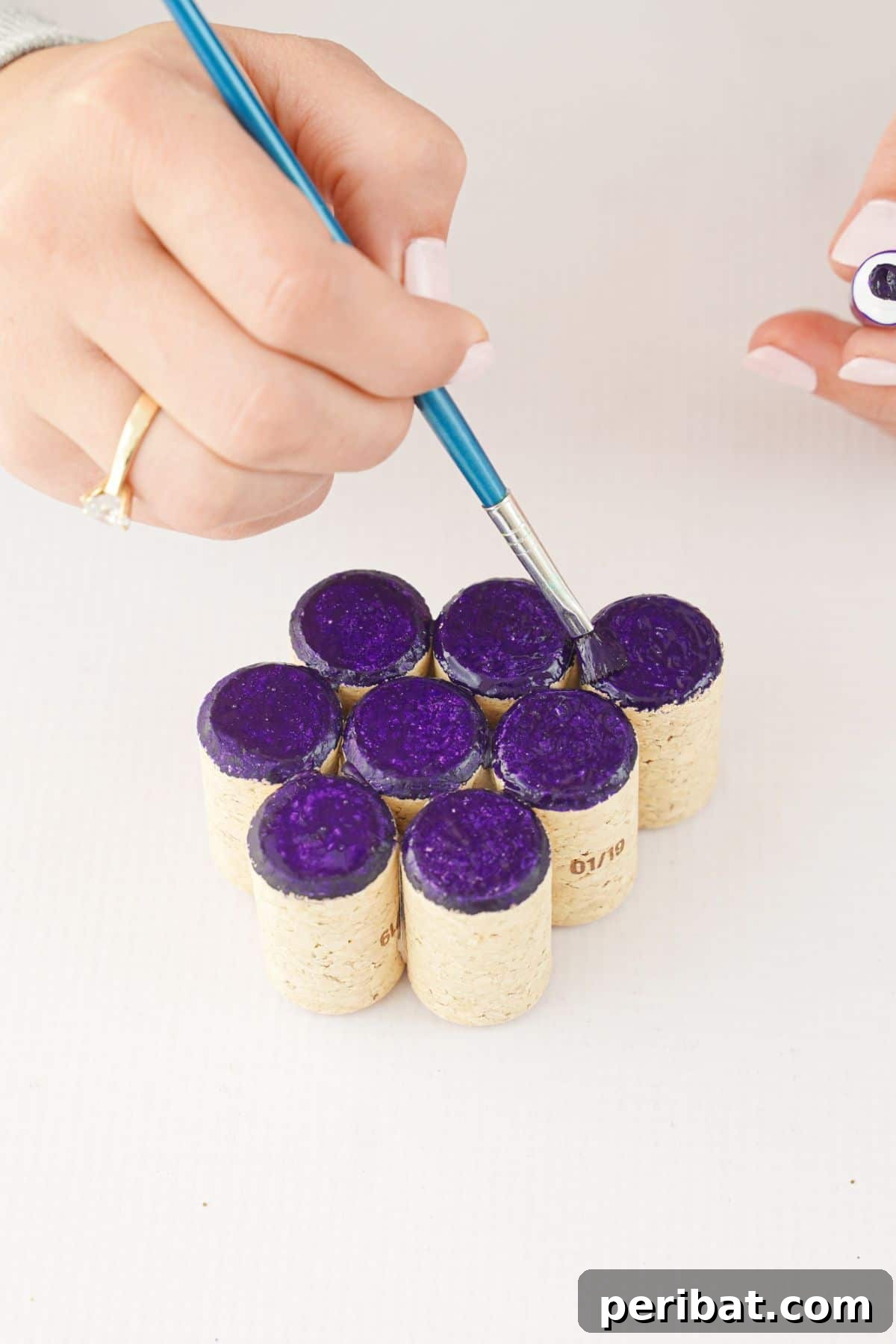 Hand painting the tops of corks purple for the grape cluster.