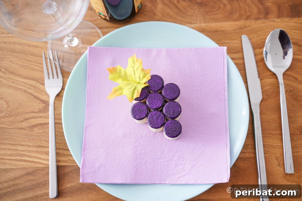 Round white plate with a lavender napkin on top, holding a finished wine cork grape cluster decoration.