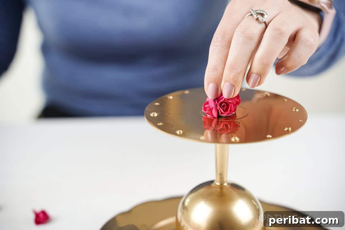 Elegant Repurposed Plate Jewelry Organizer 16 hand holding fake rose on top of gold earring and jewelry holder