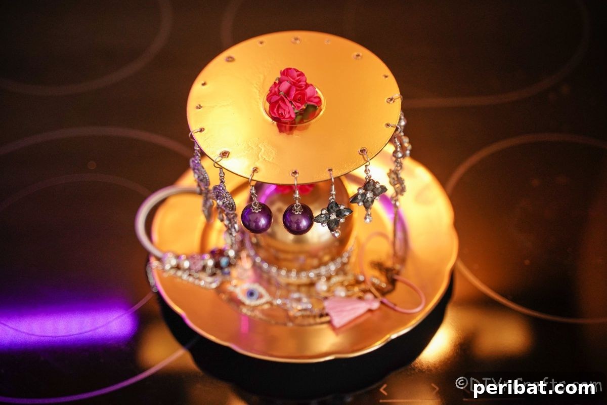 Elegant Repurposed Plate Jewelry Organizer 21 gold jewelry stand on black table with jewelry on top of stand