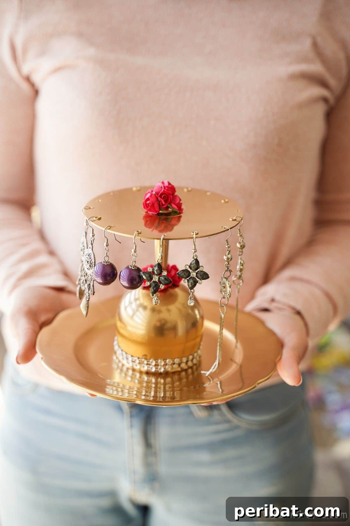 Elegant Repurposed Plate Jewelry Organizer 8 woman in jeans and pink sweater holding gold 2-tier jewelry stand