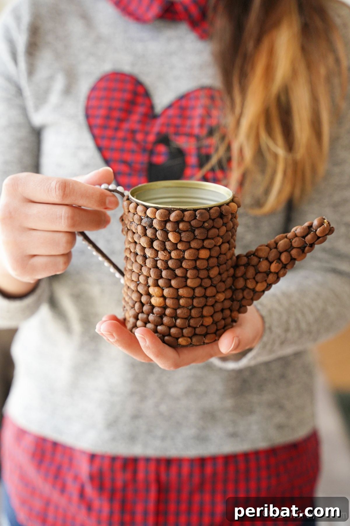 Rustic Coffee Motif Tin Watering Can 2 Woman holding a finished rustic upcycled tin can watering can decoration