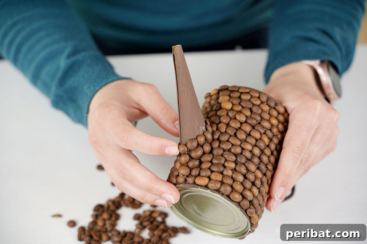 Rustic Coffee Motif Tin Watering Can 19 Hand gluing coffee beans onto the spout of the upcycled watering can, ensuring full coverage