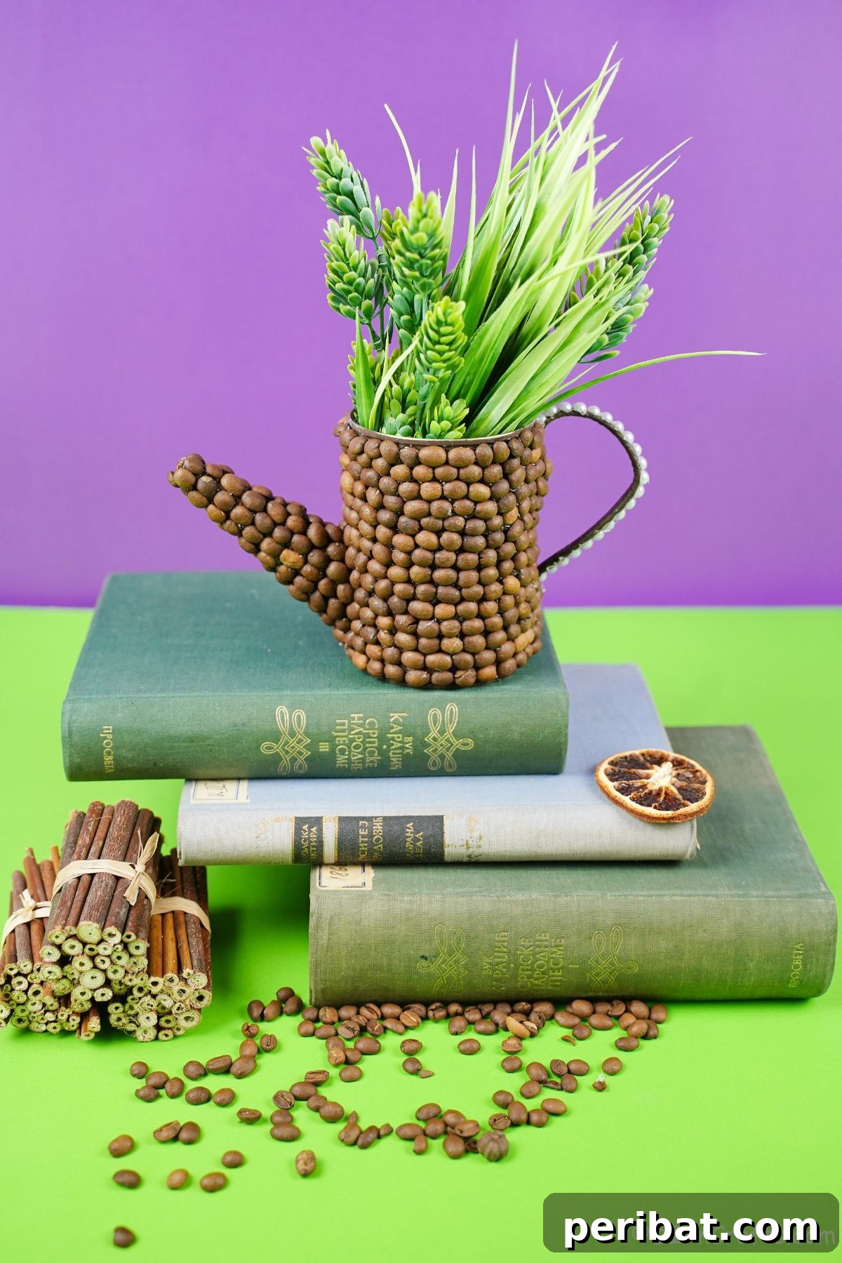 Rustic Coffee Motif Tin Watering Can 22 Greenery in a coffee bean coated upcycled watering can on a stack of vintage books