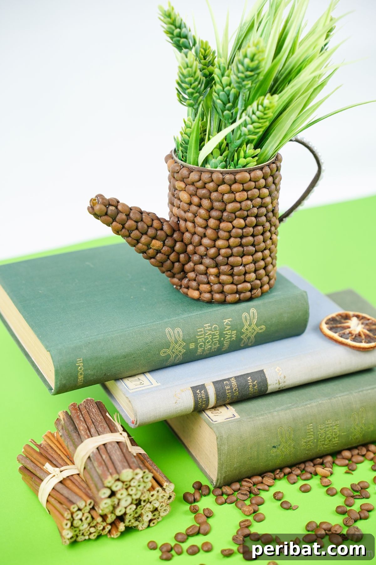 Rustic Coffee Motif Tin Watering Can 23 Stack of books with a fake upcycled watering can on top, adding a decorative touch