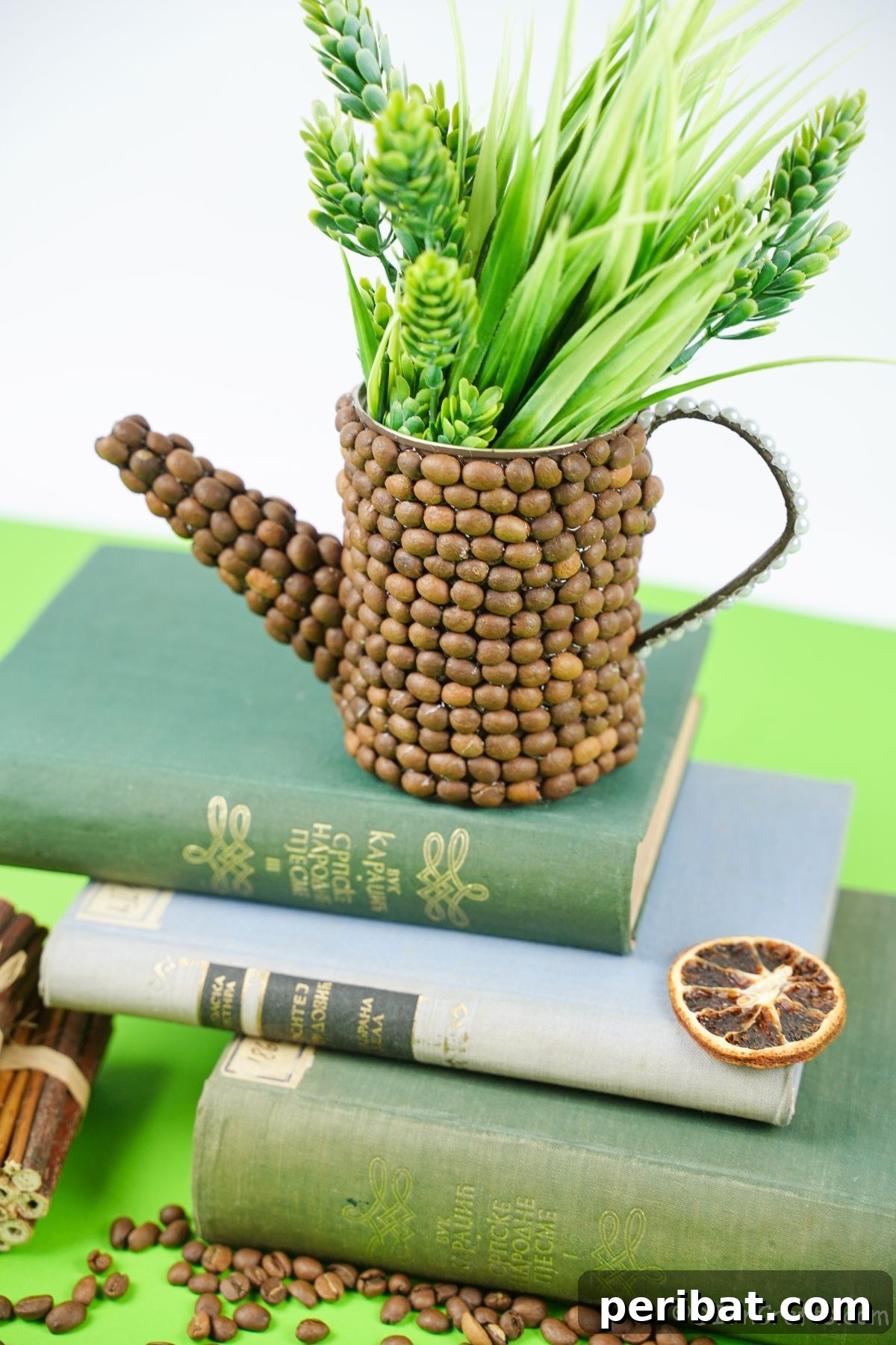 Rustic Coffee Motif Tin Watering Can 5 Rustic upcycled tin can watering can filled with artificial greenery on a stack of books