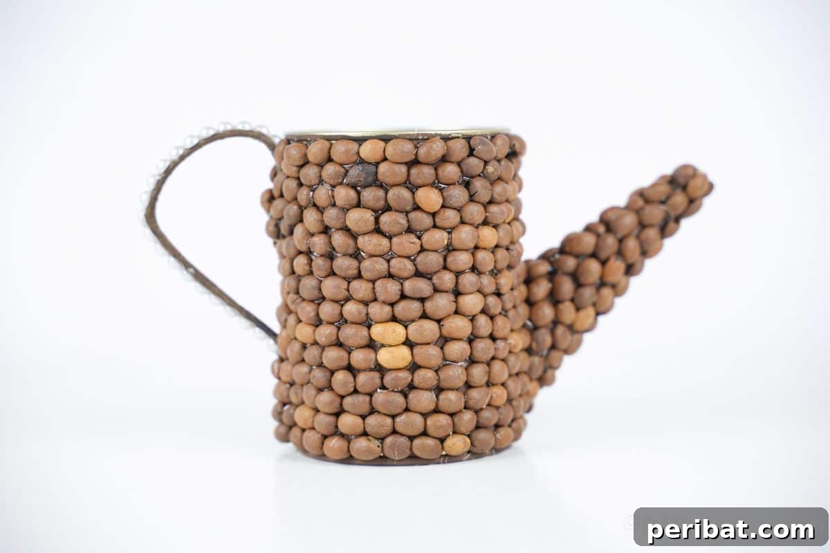 Rustic Coffee Motif Tin Watering Can 8 Rustic upcycled tin can watering can covered in coffee beans on a white table with blurred background