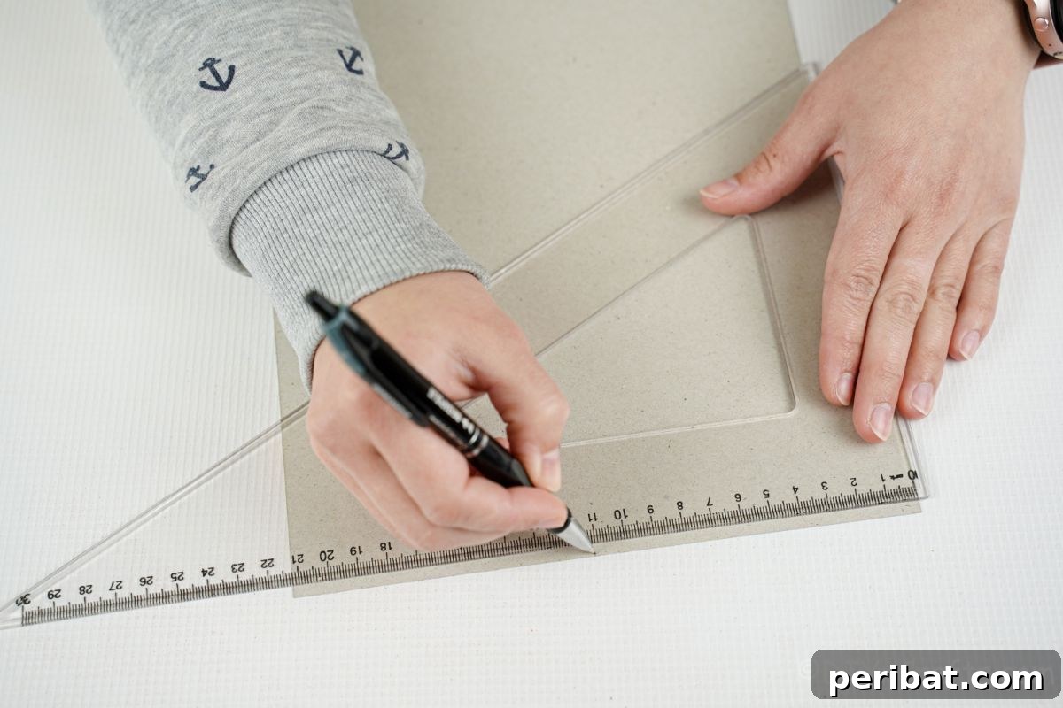 Vibrant Upcycled Tin Can Wind Socks 9 A ruler and pen are used to precisely measure and mark scrapbook paper, preparing it for wrapping around the tin can.