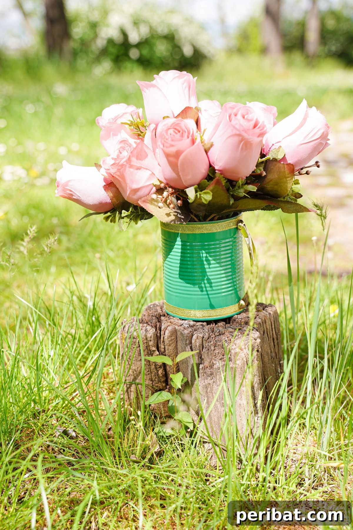 pink roses inside light green and gold tin can on stump