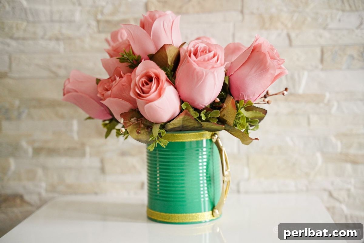 pink roses in green tin can with gold handle on white table