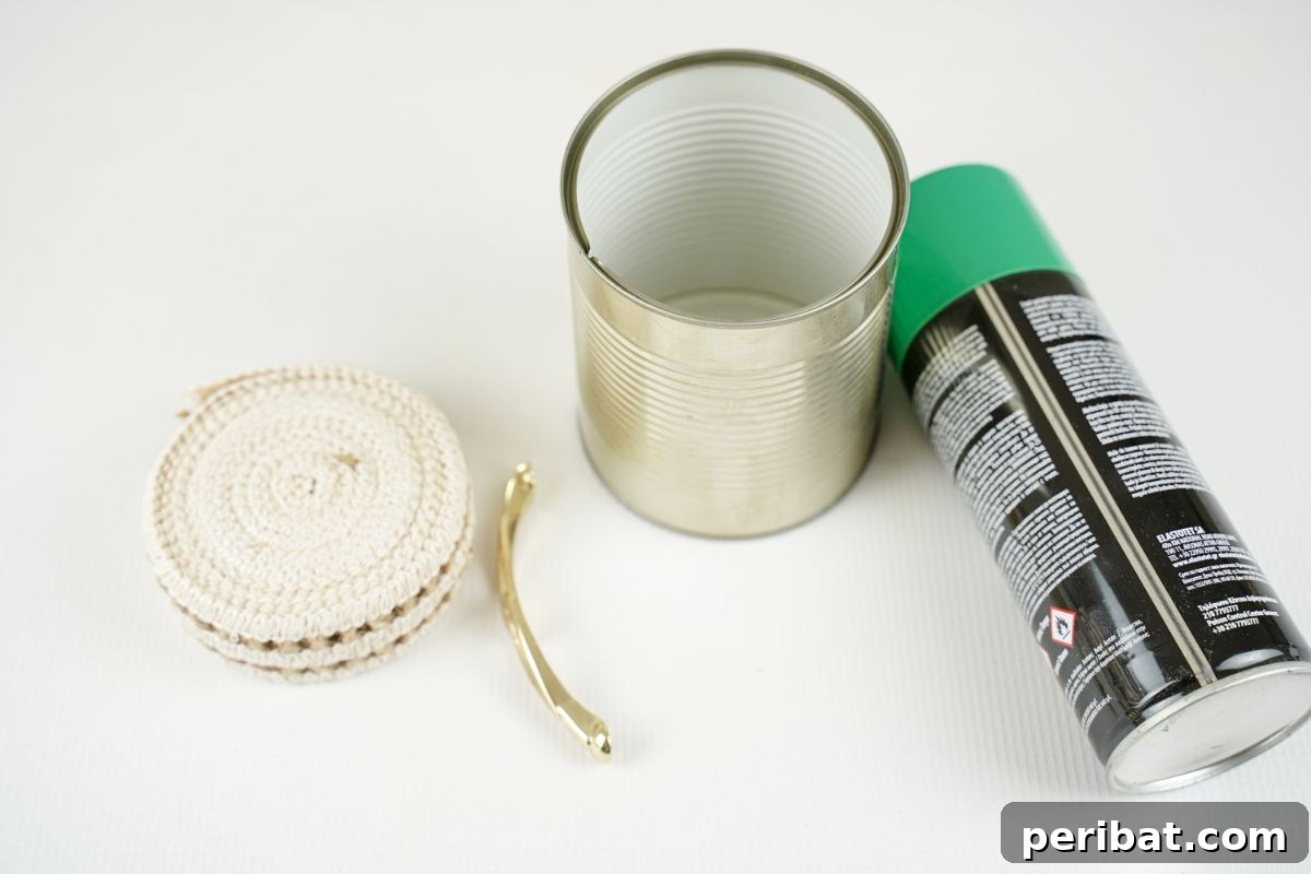 tin can ribbon gold handle and green pant on white table