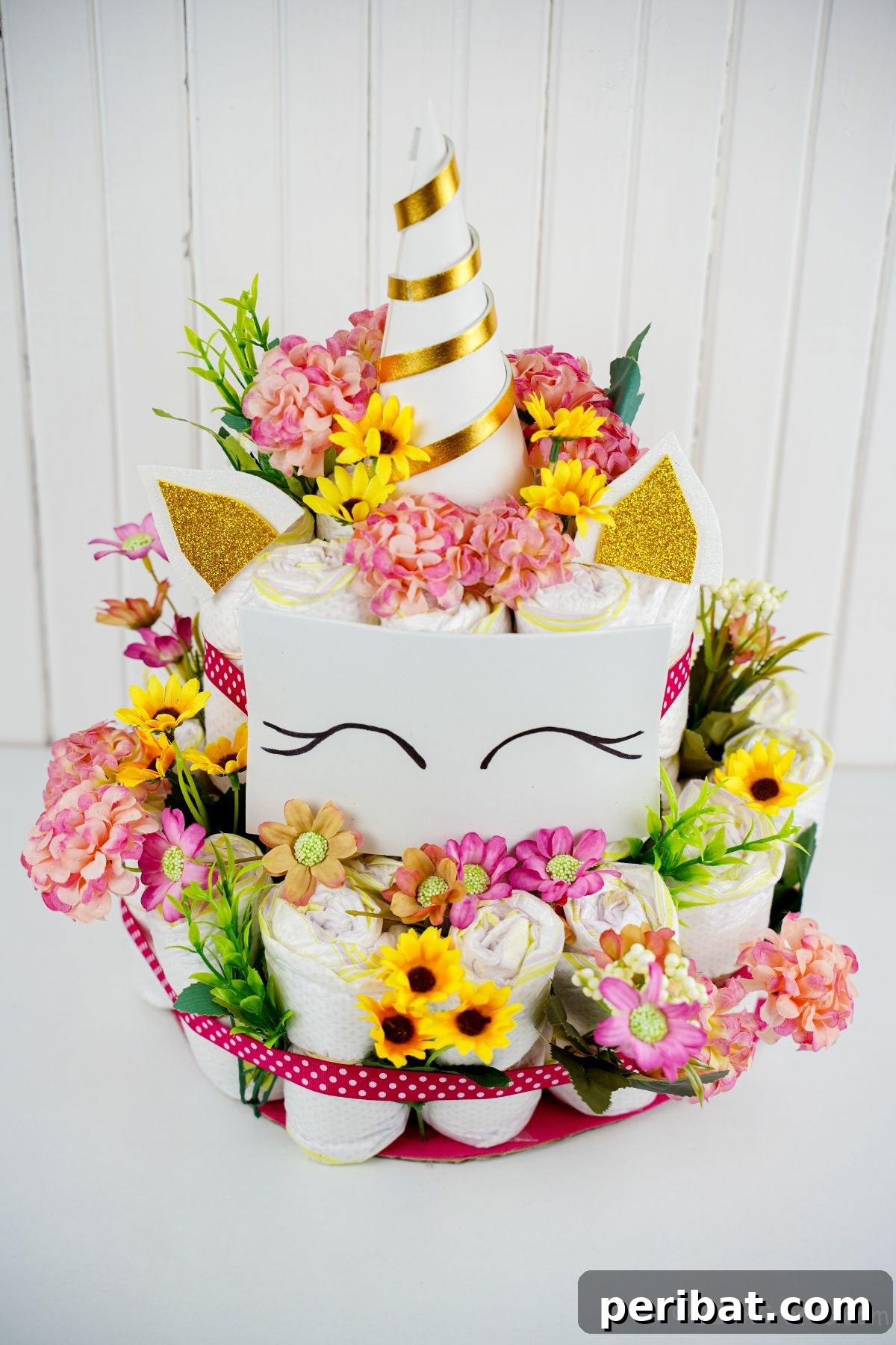 Create a Magical Unicorn Diaper Cake 4 Diaper cake unicorn on a table with a clean white background