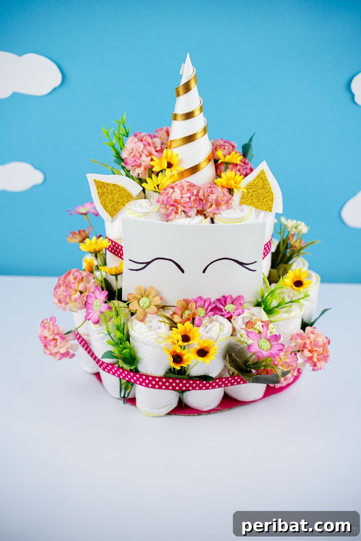 Create a Magical Unicorn Diaper Cake 24 Unicorn diaper cake in front of a blue cloud background, creating a dreamy scene
