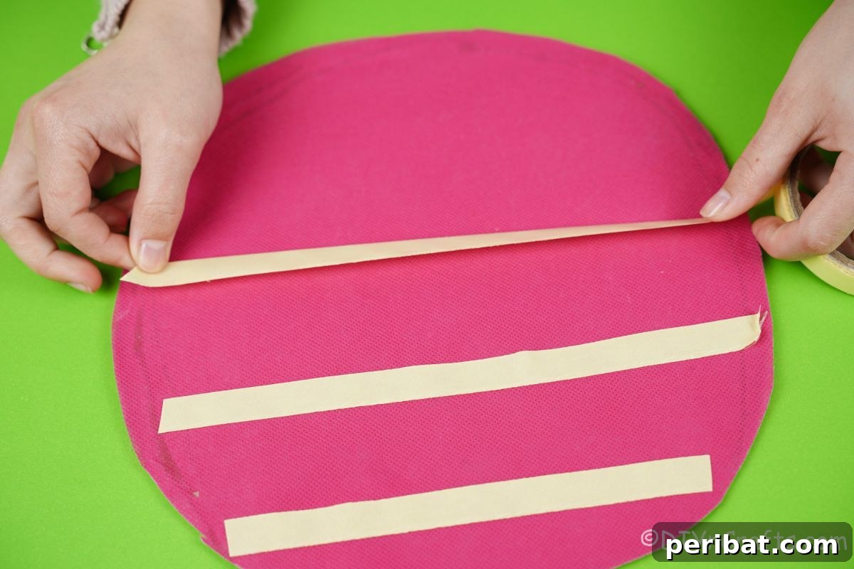 Create a Magical Unicorn Diaper Cake 9 Hand adding tape to a pink diaper cake base
