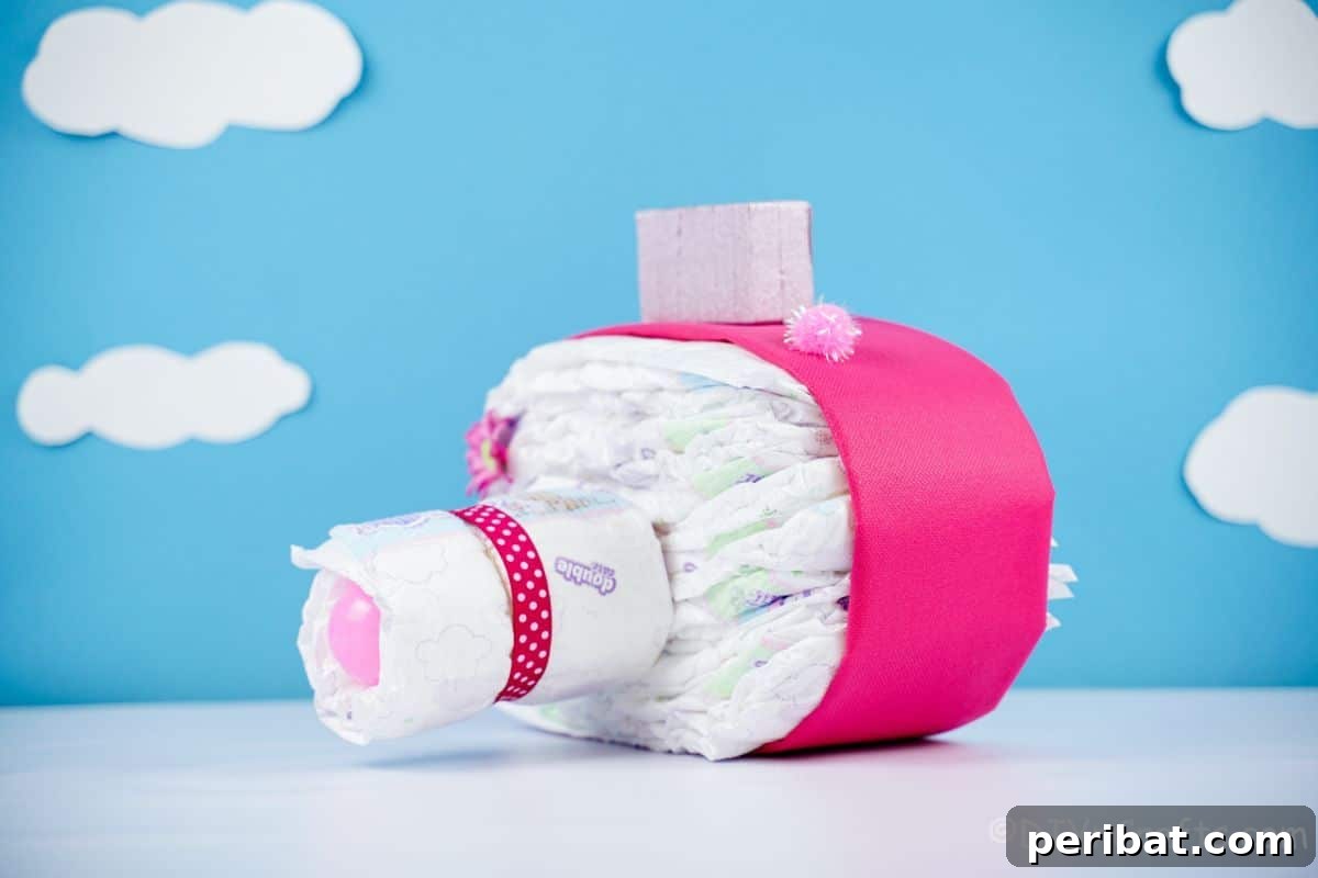 Picture Perfect Diaper Cake Camera 5 Close-up of a pink camera diaper cake with stylish blue background, highlighting details