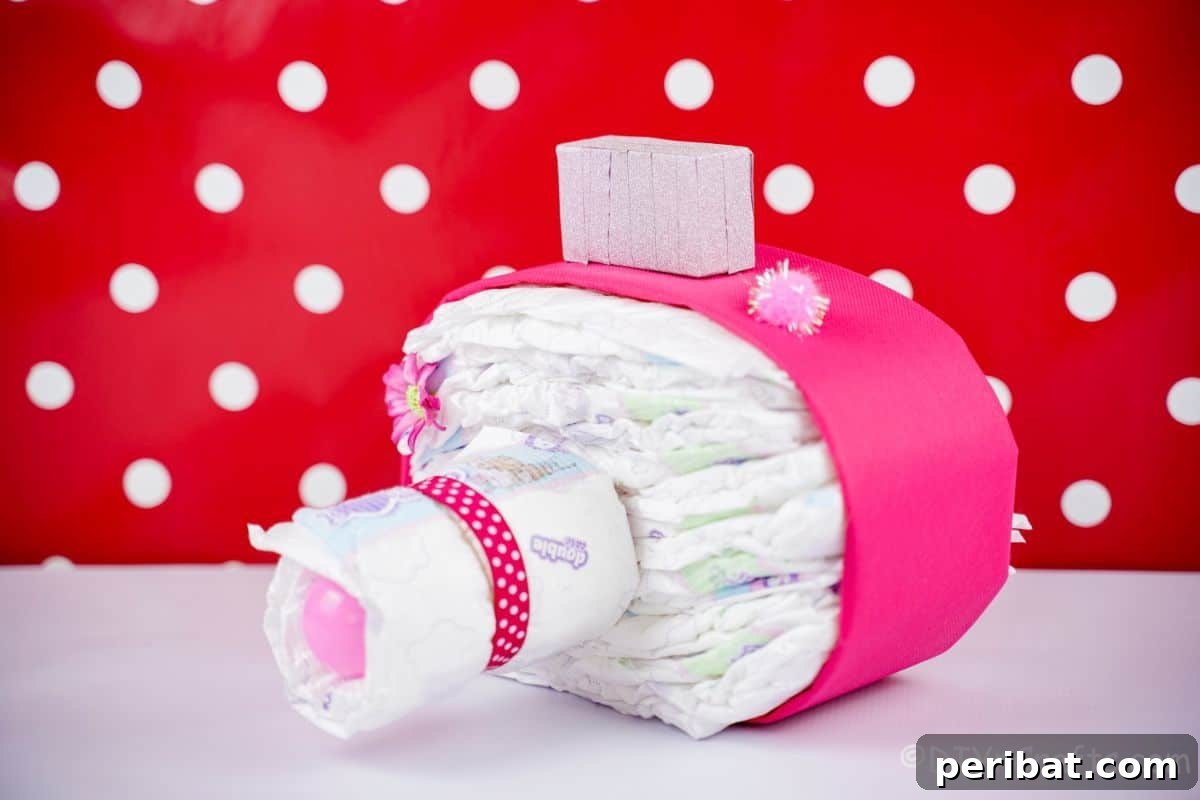 Picture Perfect Diaper Cake Camera 6 Chic pink camera diaper cake against a vibrant red and white polka dot background