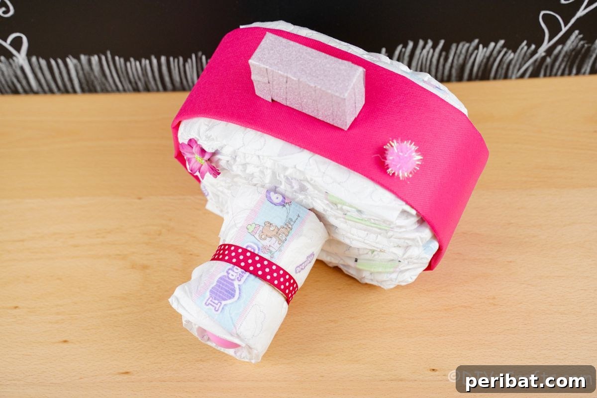 Picture Perfect Diaper Cake Camera 8 Overhead view of a perfectly crafted pink camera diaper cake, showcasing its design