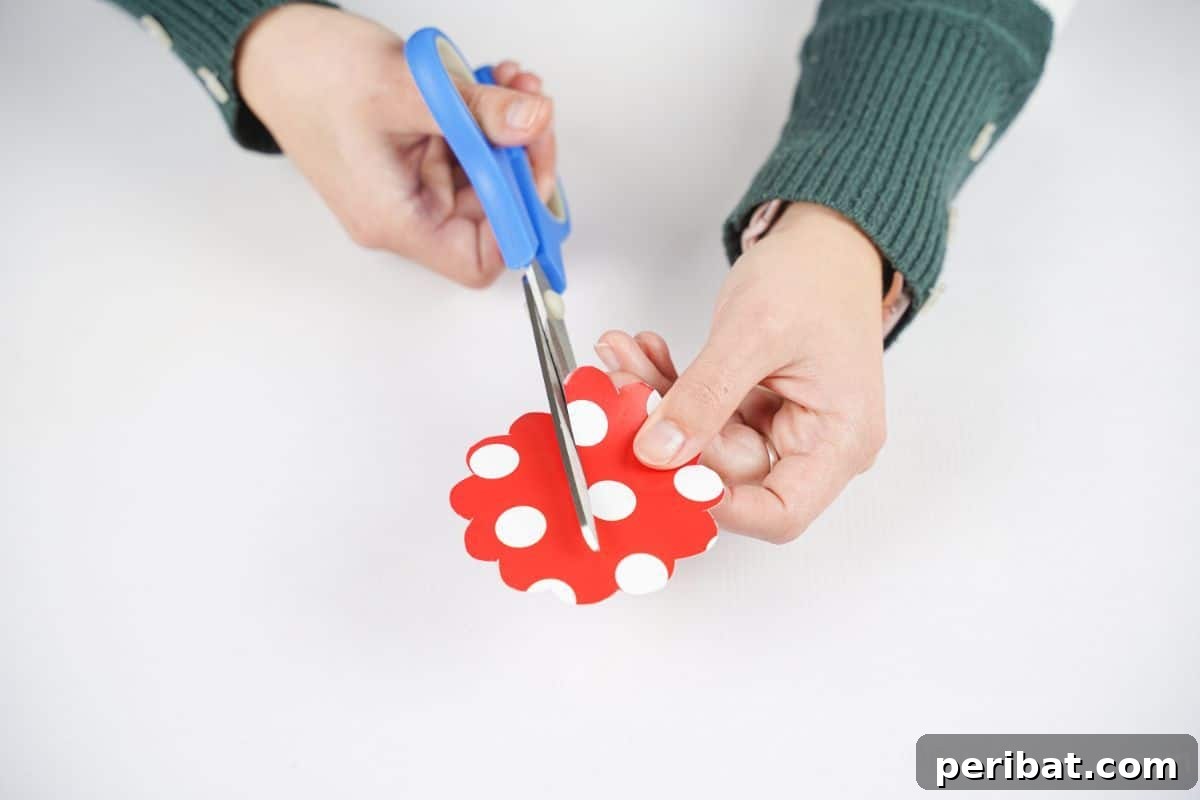 hand cutting red and white polka dot circle