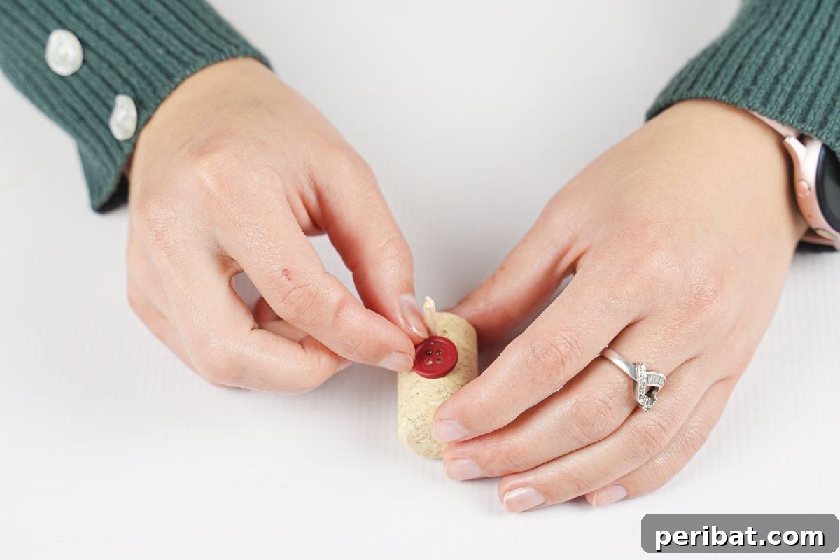 gluing button on top of wine cork