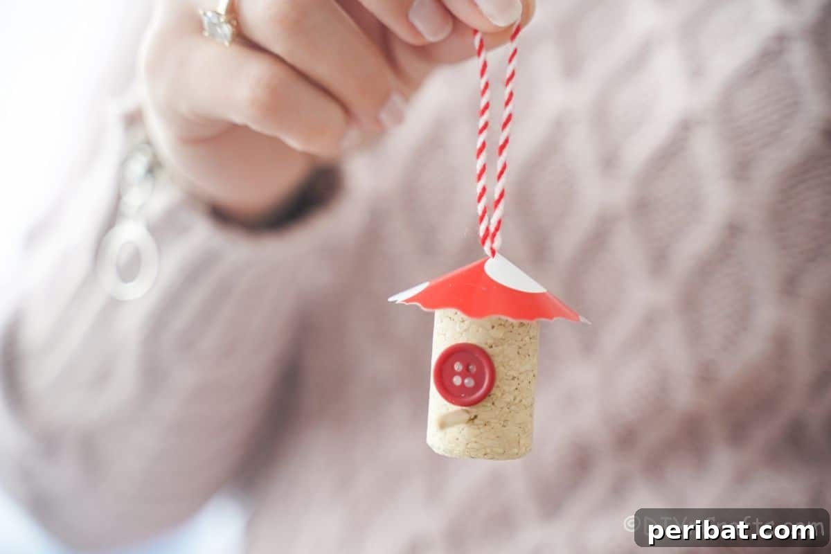 wine cork birdhouse being held by woman in pink