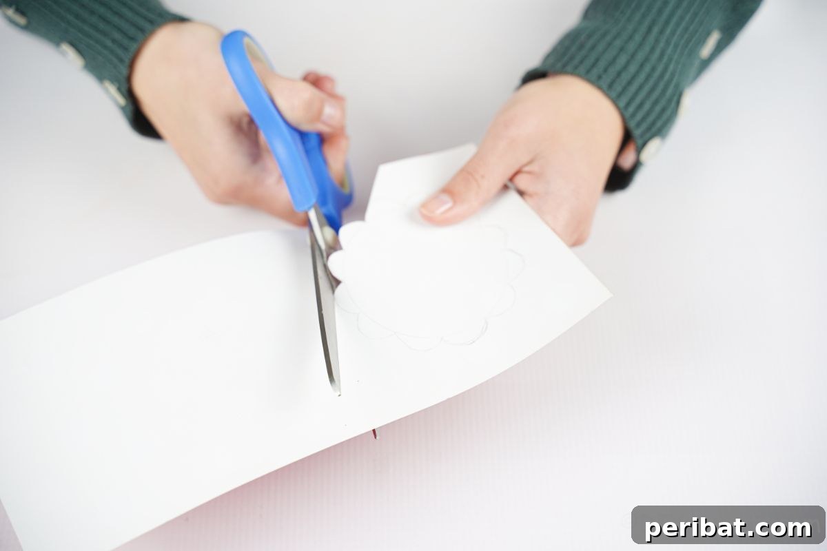 hand cutting paper with blue scissors