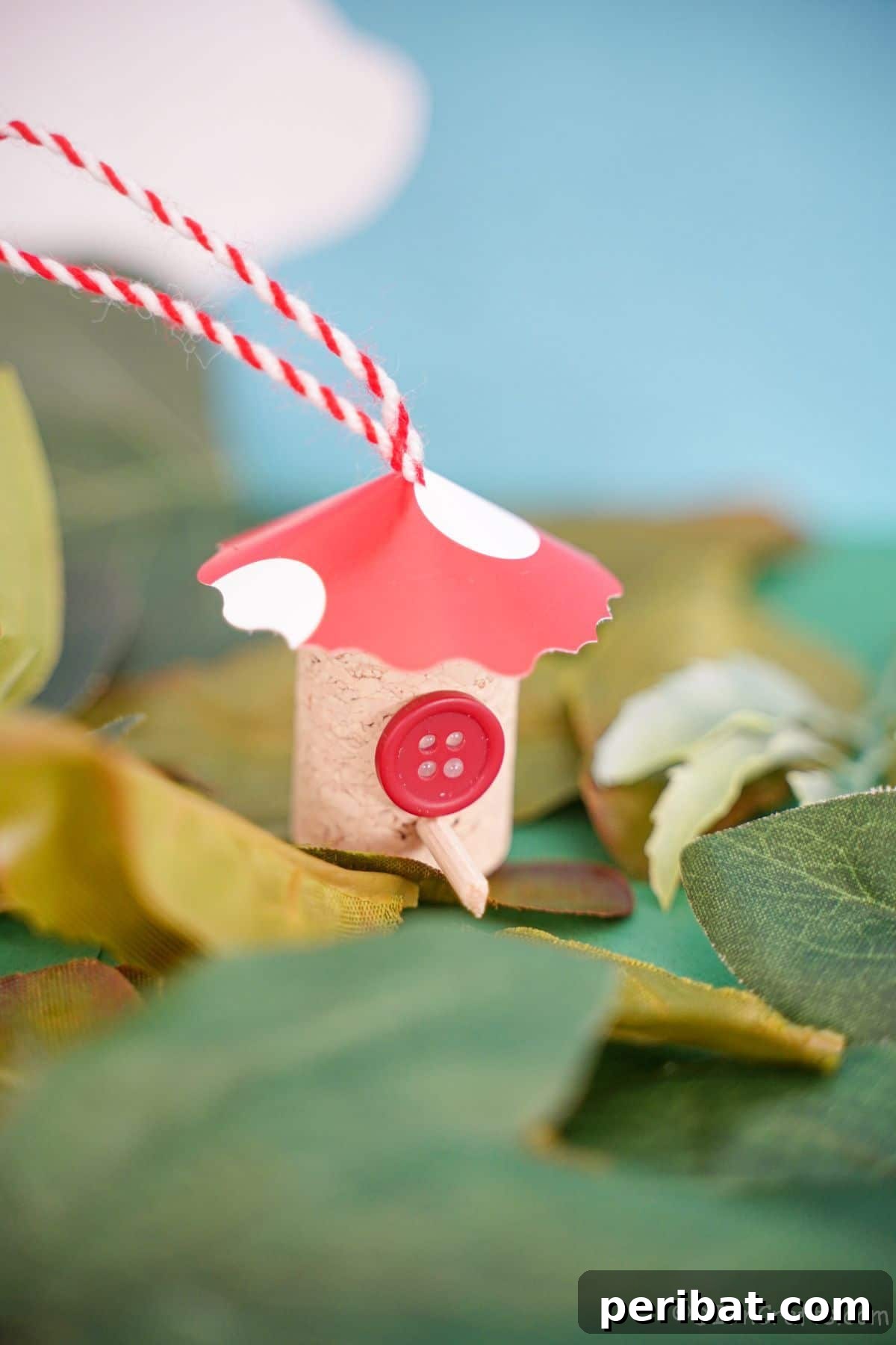 red roof on wine cork house on fake leaves