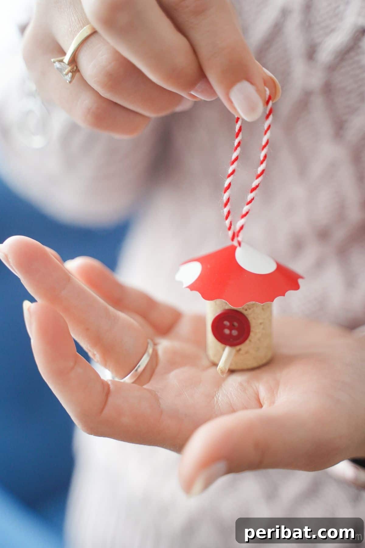 red roof on mini wine cork birdhouse in womans hand