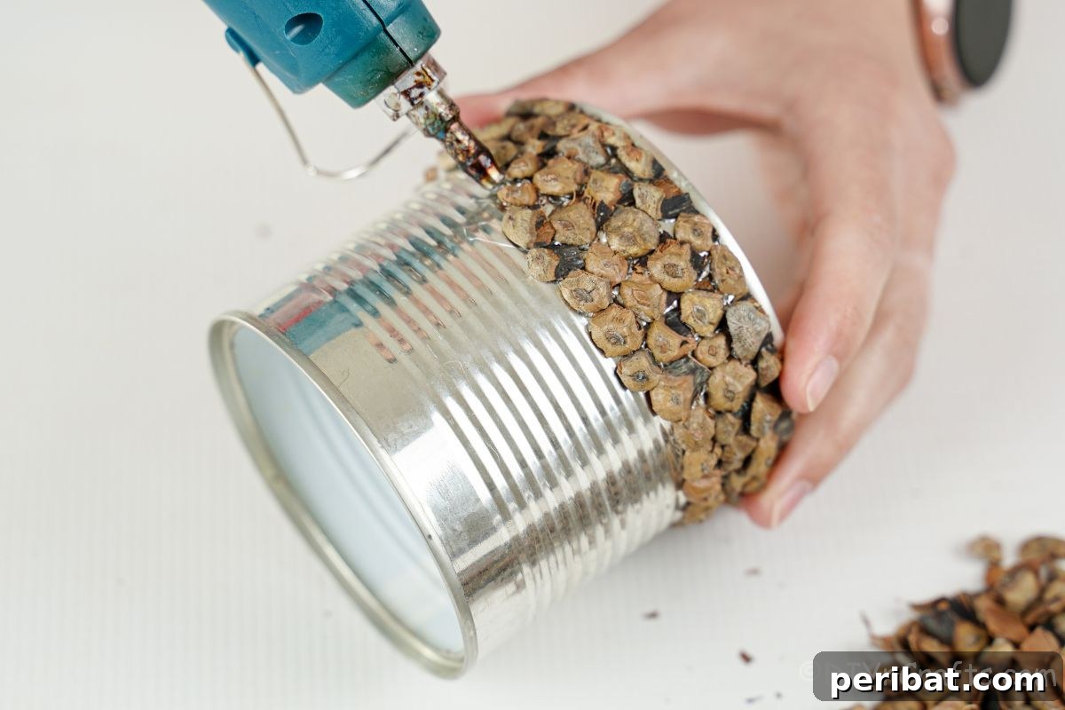 Nature-Inspired Upcycled Tin Can Planters 19 pinecone scales being glued to tin can