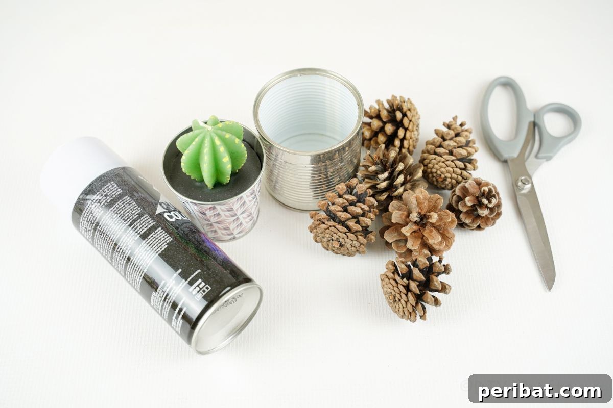 Nature-Inspired Upcycled Tin Can Planters 9 Various craft supplies including pinecones, scissors, a tin can, a candle, and white spray paint, neatly arranged on a white table, ready for crafting.