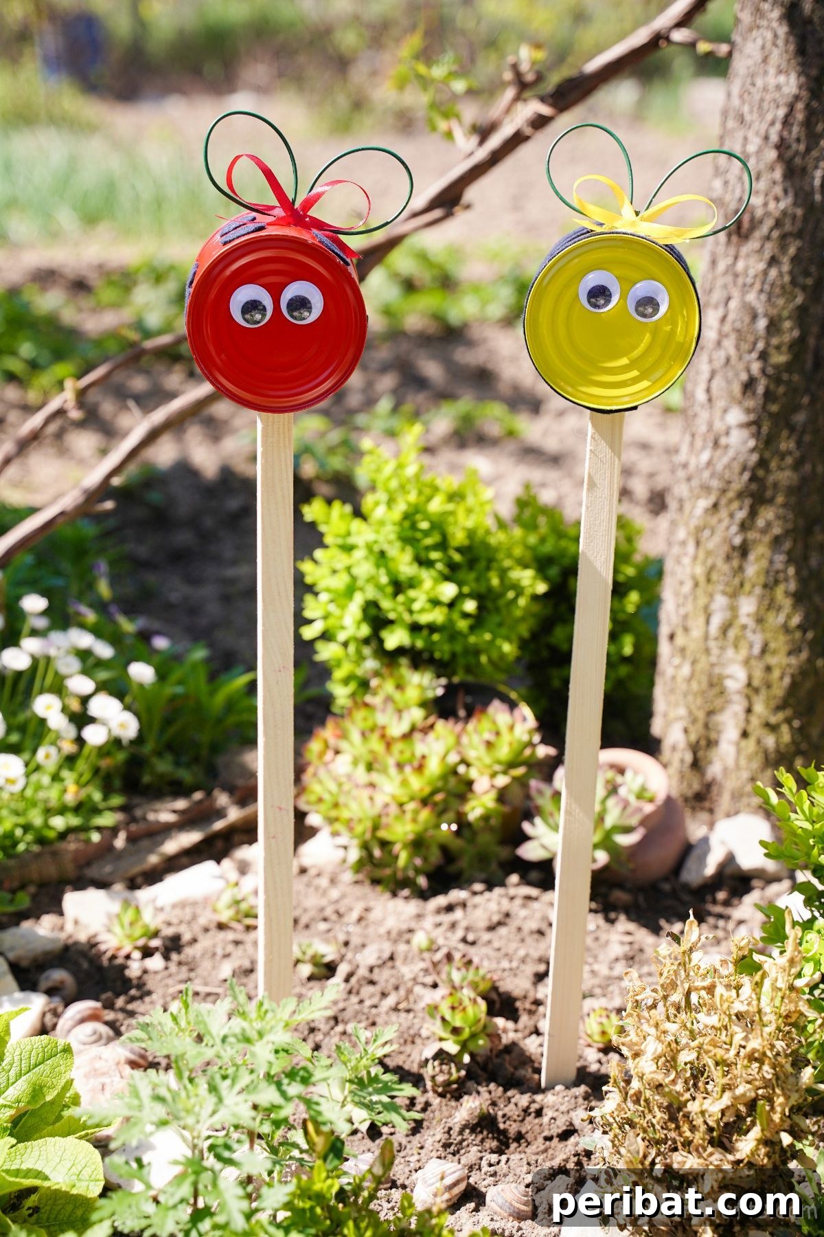 ladybug and bee sticks in garden soil