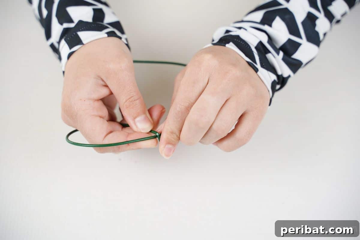 hand shaping wire into wings