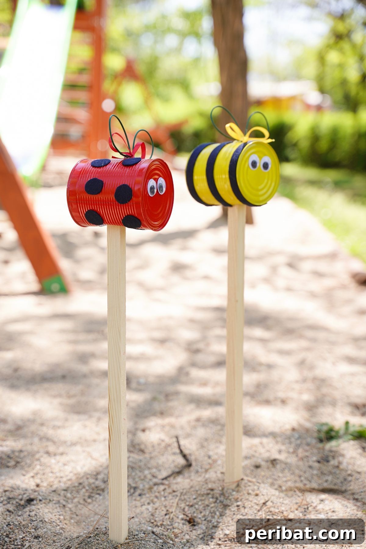 tin can garden decor in playground sand
