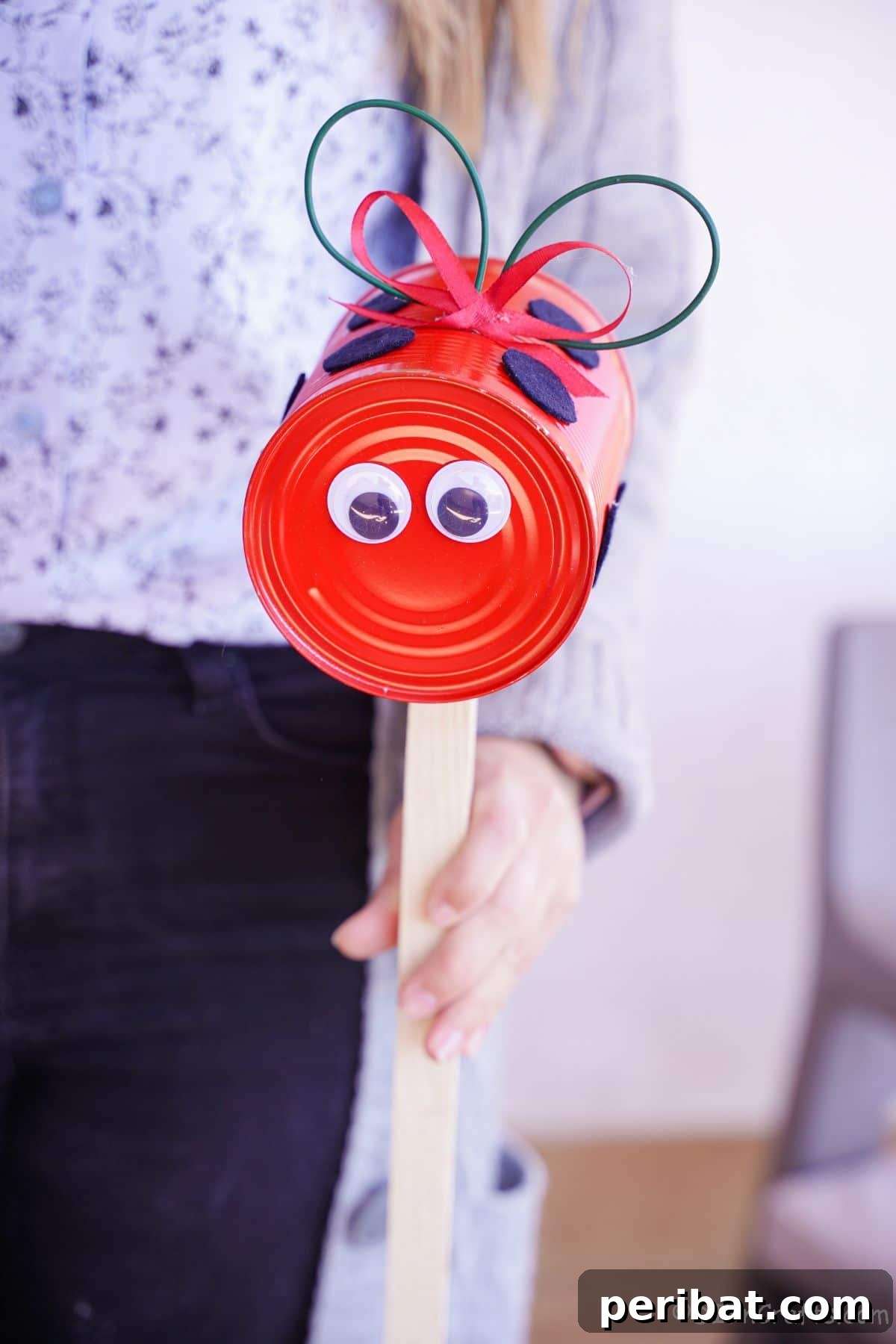 woman holding tin can ladybug