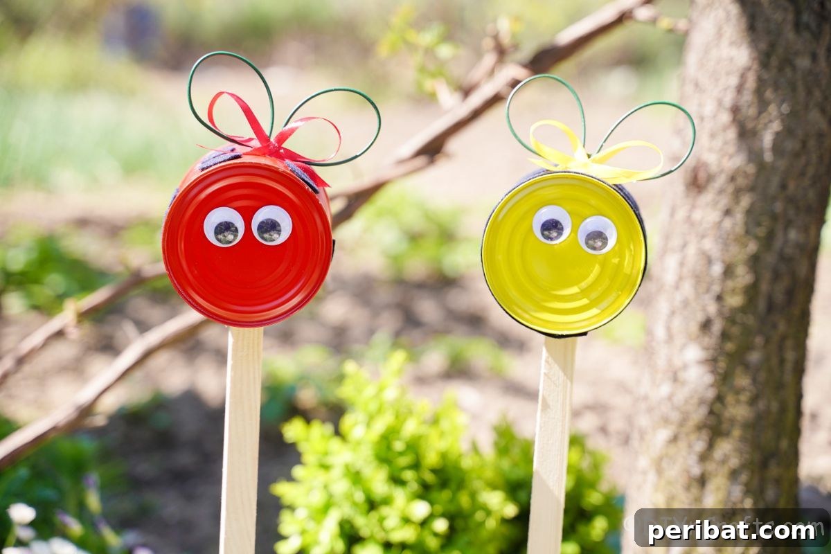 closeup of tin can bee and tin can ladybug on garden stakes