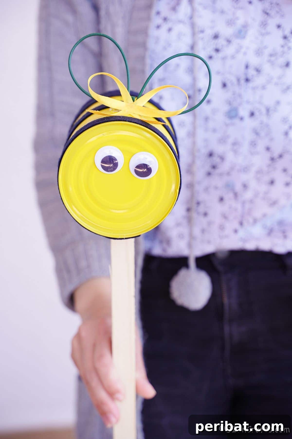tin can bumble bee being held by woman