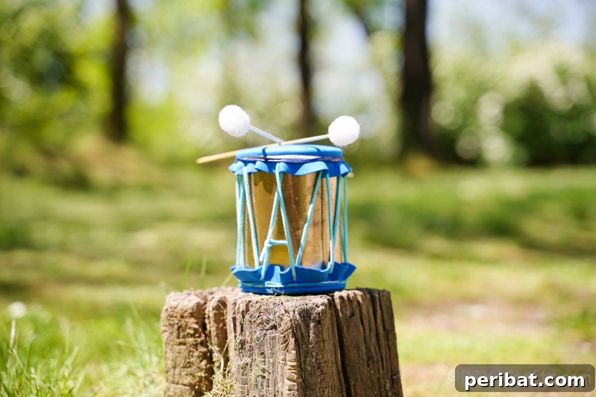 Percussion from the Pantry: Upcycled Tin Can Drums 17 blue and gold tin can drum on stump