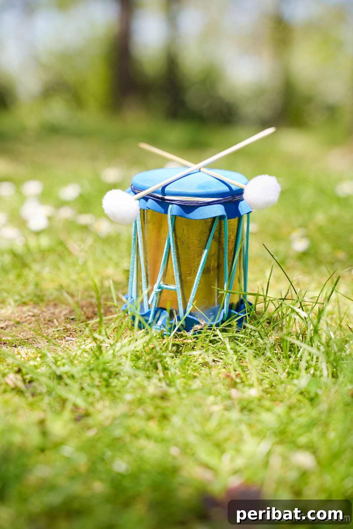 Percussion from the Pantry: Upcycled Tin Can Drums 4 gold and blue mini drum with sticks on grass