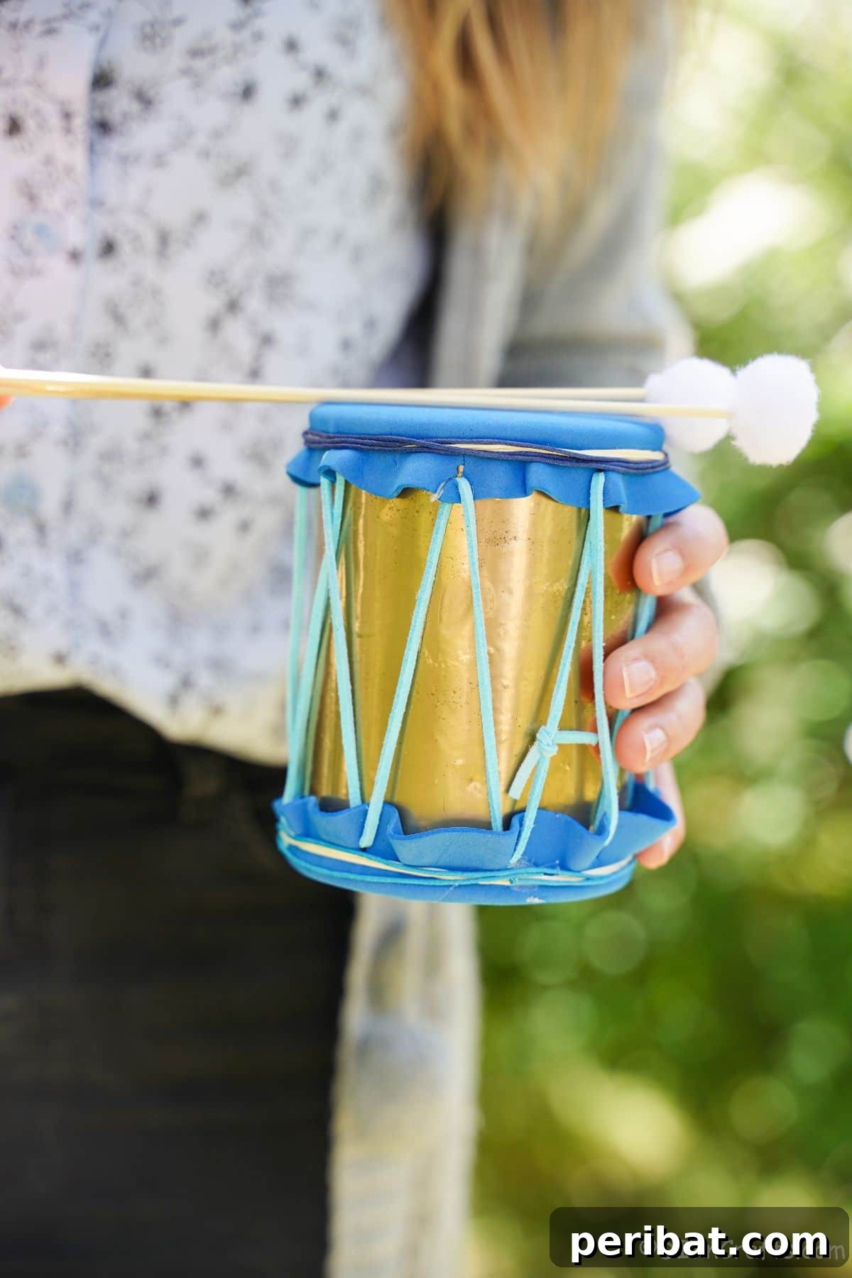 Percussion from the Pantry: Upcycled Tin Can Drums 5 lady in gray sweater holding mini tin can drum with sticks