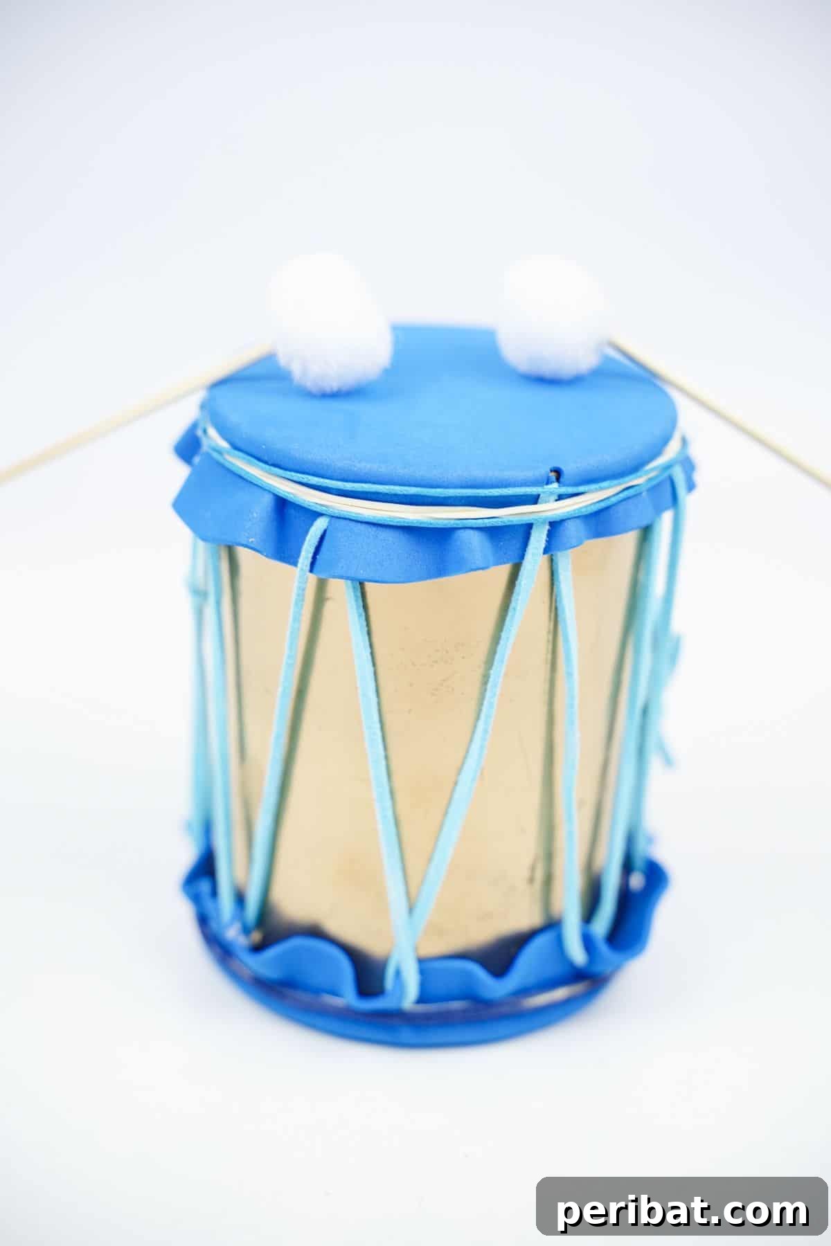 Percussion from the Pantry: Upcycled Tin Can Drums 6 blue and gold mini drum on white table