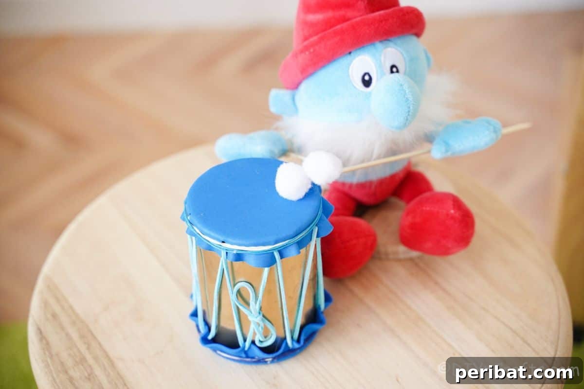 Percussion from the Pantry: Upcycled Tin Can Drums 7 papa smurf on wood stool with blue mini drum