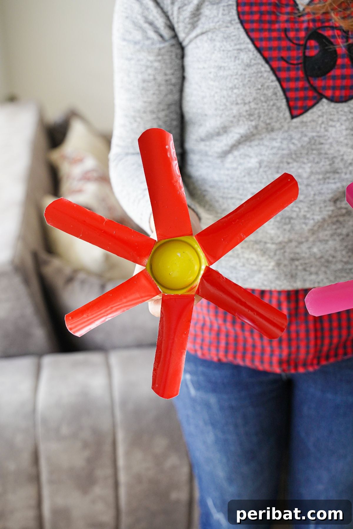 Aluminum Bloom Art 16 woman in gray and red holding red and yellow metal flower